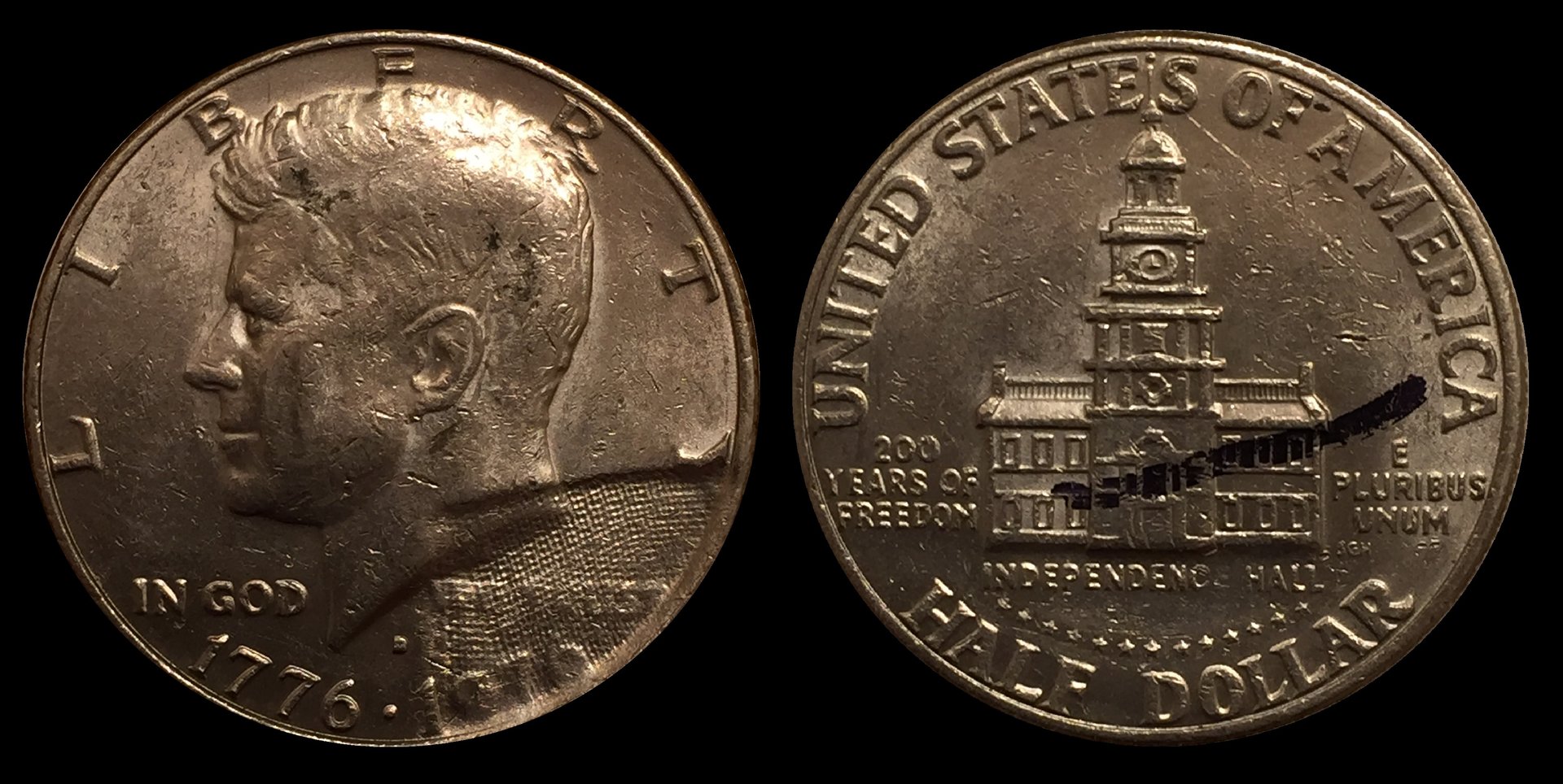 1976D Half Dollar Struck Through Cloth Before.jpg