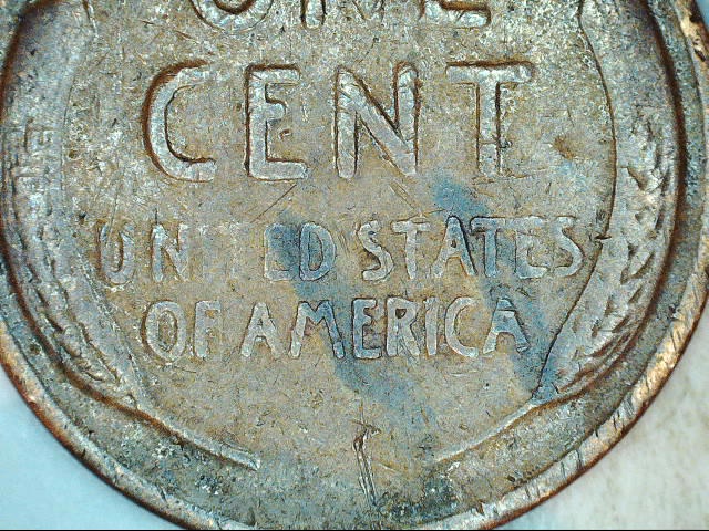 Download what type of errors is this penny. looks like struck thru something or lamination on the obverse ...