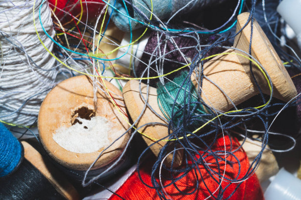 depositphotos_390907090-stock-photo-tangled-threads-sewing-different-spools.jpg