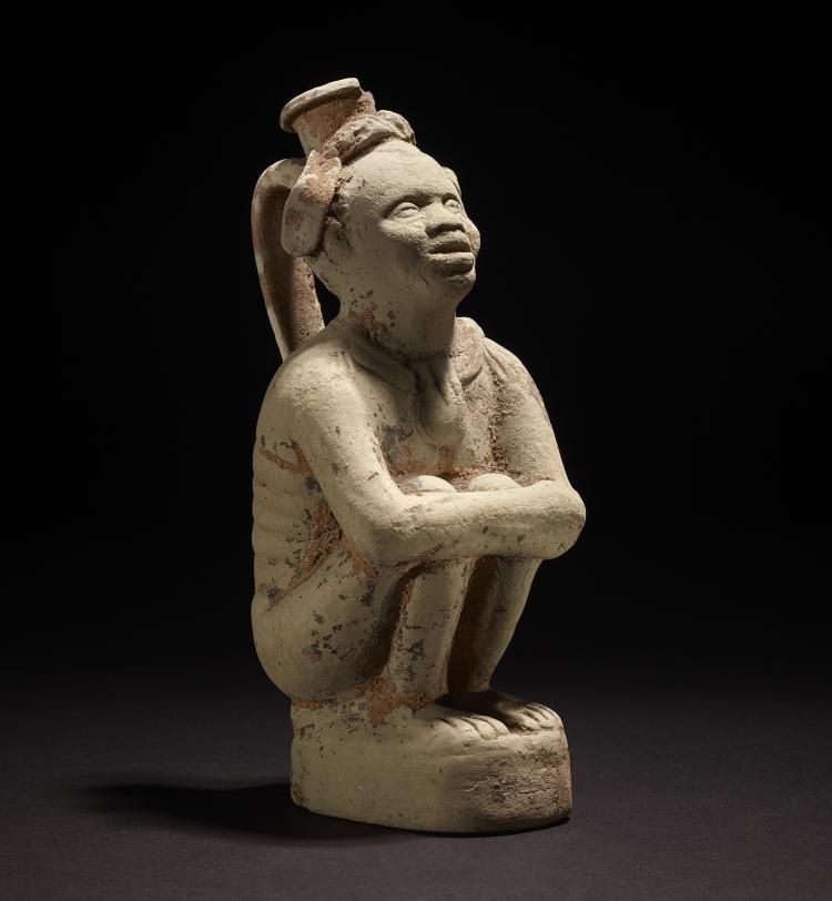 Flask shaped like a crouching African captive_1.jpg