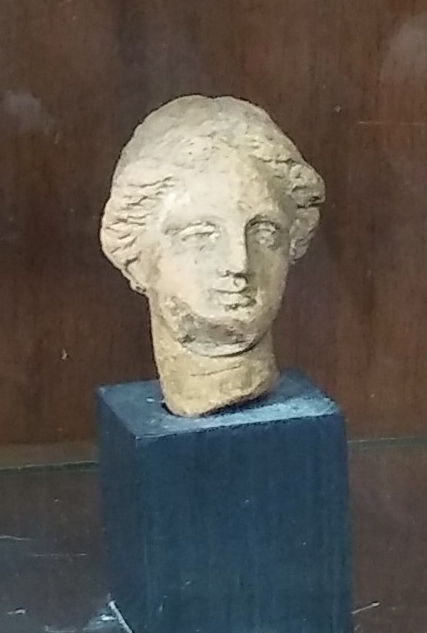 Greek female terracotta Tanagra head, face forward, slightly right (example 2).jpg
