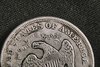 1873-S_Liberty_Seated_Dollar_Obverse_Motto_Detail-squashed.jpeg