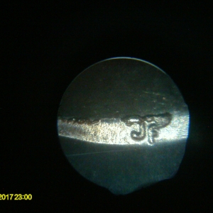 Photo A, only 1 set of Designer's initials with die chips.