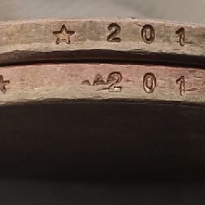 Alignment of  off and bars across edge of bottom coin and doubling stars on top