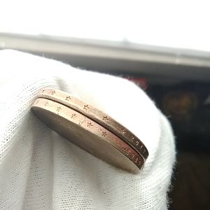 Alignment of  off and bars across edge of bottom coin and doubling stars on top