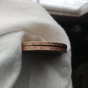 Alignment of  off and bars across edge of bottom coin and doubling stars on top