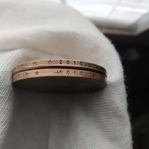 Alignment of  off and bars across edge of bottom coin and doubling stars on top