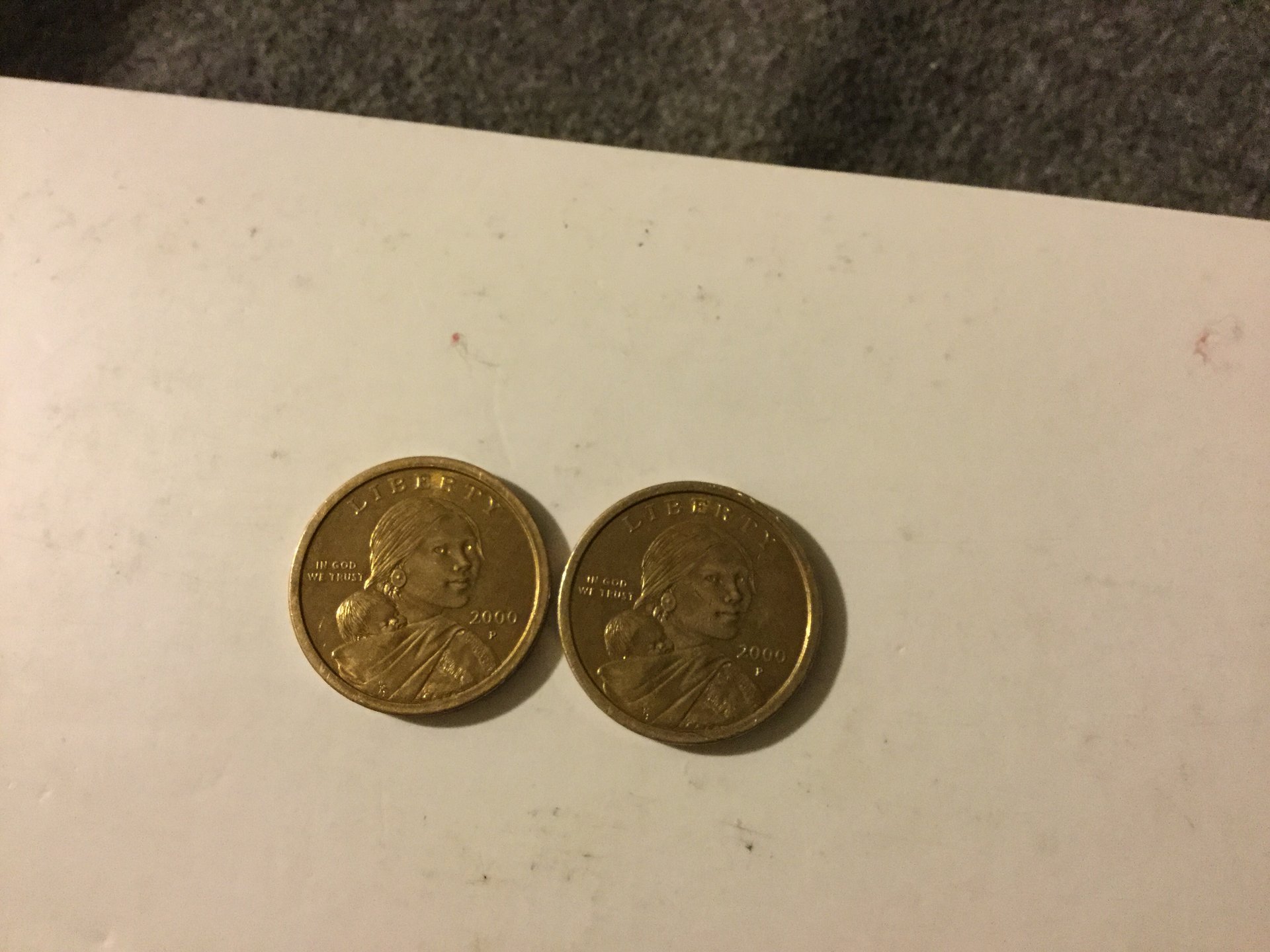 Two differently colored 2000 p dollar coins
